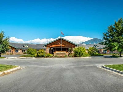Exterior view of the assisted living facility with mountains in the background