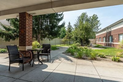 Outdoor courtyard with seating and lush greenery