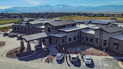 Aerial view of the Rocky Mountain Care facility with people outside