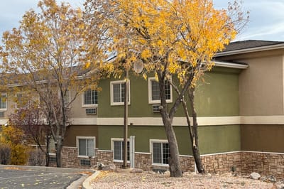 Exterior view of a senior living facility with autumn foliage