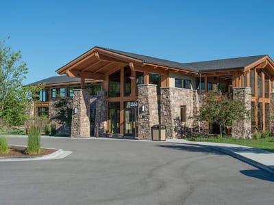 Exterior view of a senior living facility with natural landscaping