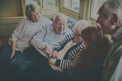Rocky Mountain Care – Summit Ridge Assisted Living OC LLC, nursing home in Douglas, WY — Seniors engaged in conversation on a comfortable couch