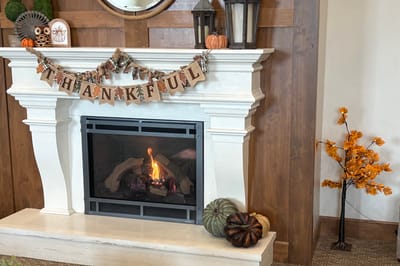 Cozy indoor fireplace decorated for fall