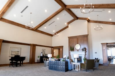 Bright common area with cozy seating and a piano