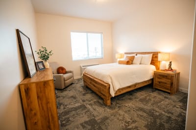 Cozy private bedroom with wooden furniture