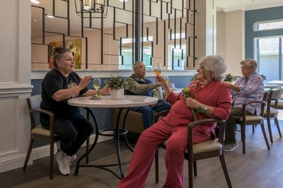 Residents enjoying drinks and conversation in a common area