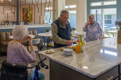 Residents enjoying a cooking activity in the common area