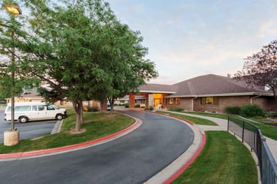 Entrance of a senior living facility with outdoor landscaping