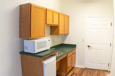 Interior kitchenette with cabinets and appliances