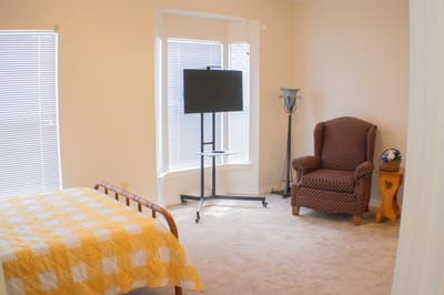 Cozy resident room with a bed and seating