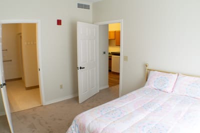 A cozy private resident room with a bed and kitchen