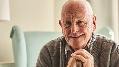 Senior man smiling in a cozy indoor setting