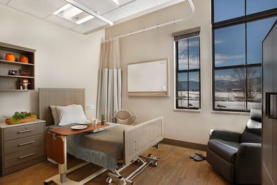 A cozy resident room with a bed and scenic view