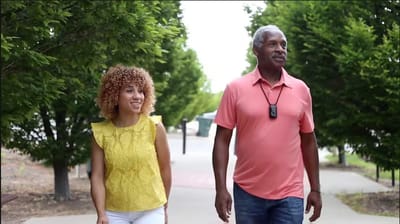 Rocky Mountain Care – Summit Ridge Assisted Living OC LLC, nursing home in Douglas, WY — Two people walking together along a tree-lined path
