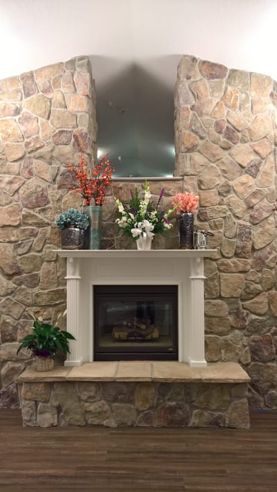 Decorative stone fireplace with flower arrangements