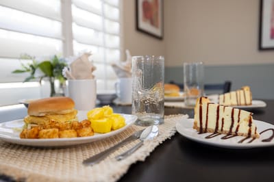 Breakfast spread with eggs, potatoes, and cake