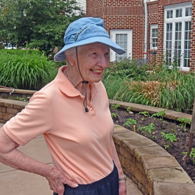 Smiling resident in a garden area