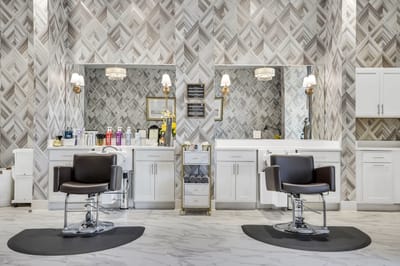 Bright and modern hair salon area with two styling chairs
