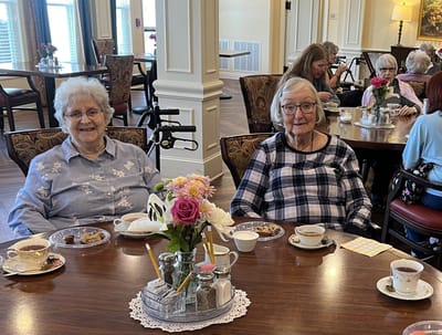 Residents enjoying tea and snacks in a dining room