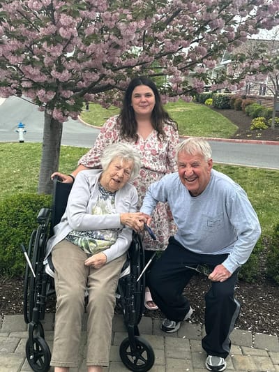 Residents enjoying time outdoors under a flowering tree