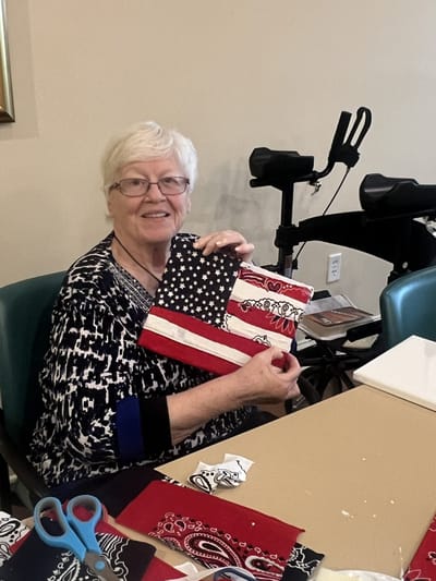 Resident creating a craft project at a table