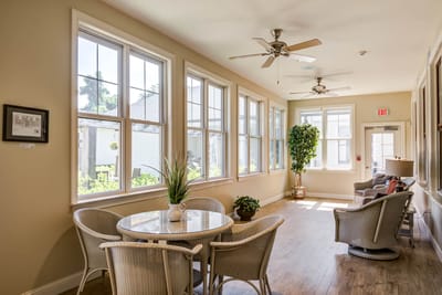 Bright common area with large windows and seating