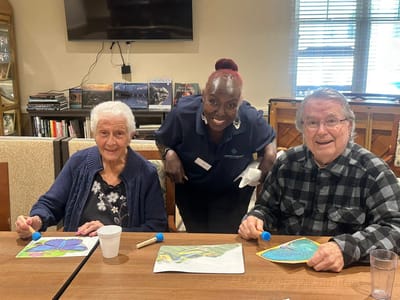 Residents engaging in an art activity with staff