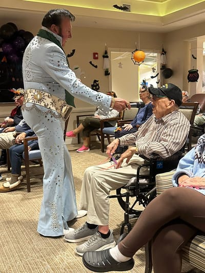 A performer engaging with residents during an event