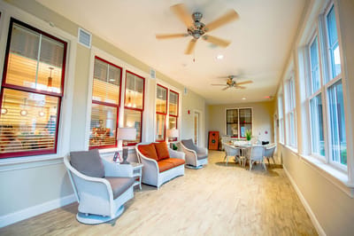 Bright common area with seating and large windows