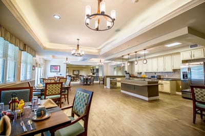 Bright dining area with tables and kitchen space
