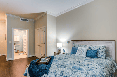 Brightly lit private resident room with comfortable furnishings