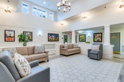 Bright and inviting lobby area with couches and artwork