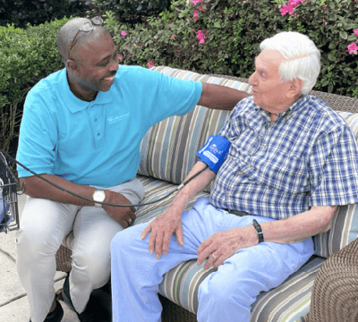 A staff member interacting with a resident outdoors