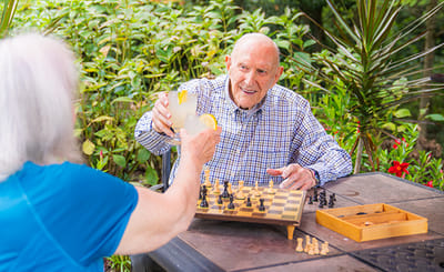 Residents enjoying a game of chess outdoors
