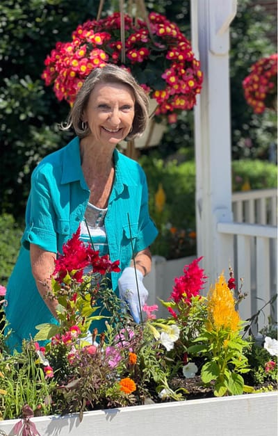 A resident gardening in a vibrant outdoor space