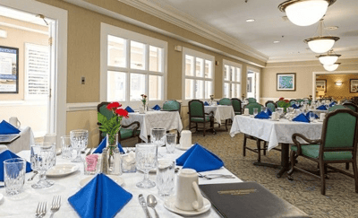Dining room set for a meal with blue napkins