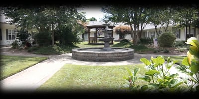 A tranquil courtyard with a fountain and seating area