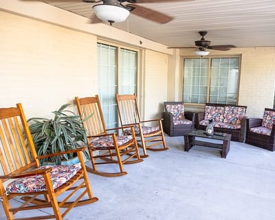 Outdoor seating area with rocking chairs and decor