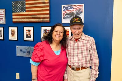 Resident celebrating with a staff member indoors
