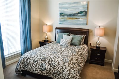 Cozy resident room with a bed and artwork