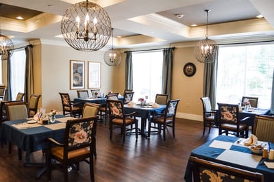 Bright dining room with tables set for meals