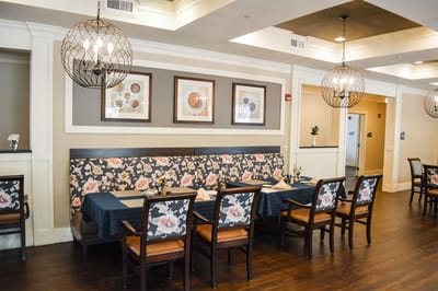 Dining area with floral seating and wall art