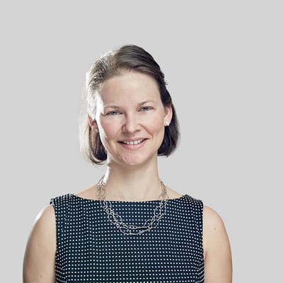 Portrait of a smiling woman against a neutral background
