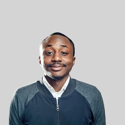 Man smiling against a gray background
