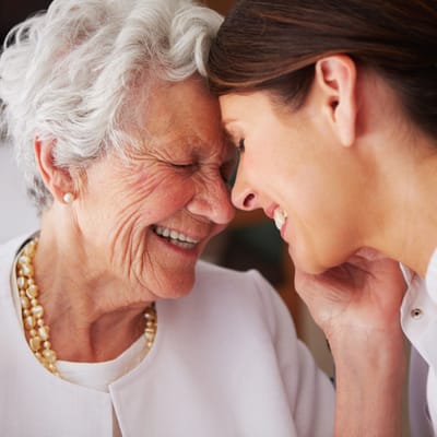 A joyful interaction between a resident and a caregiver