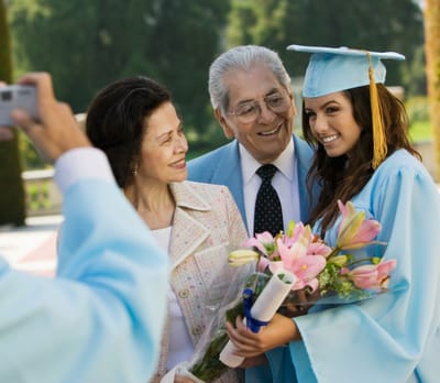 Group celebrating graduation outdoors
