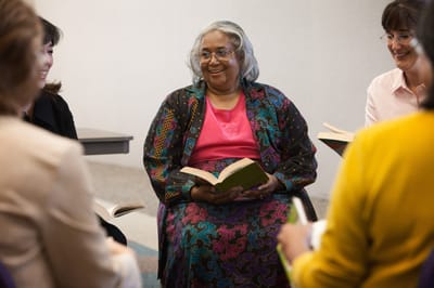 Residents engaging in a reading activity in a shared space