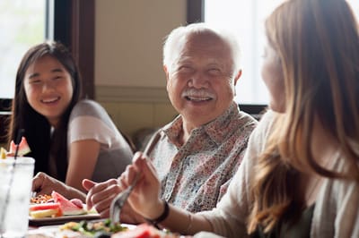 Residents enjoying a meal together with smiles
