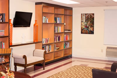Cozy interior common area with bookshelves and seating