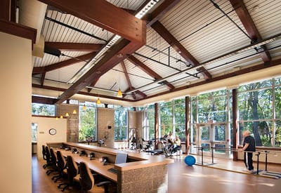 Interior view of a fitness area with residents exercising